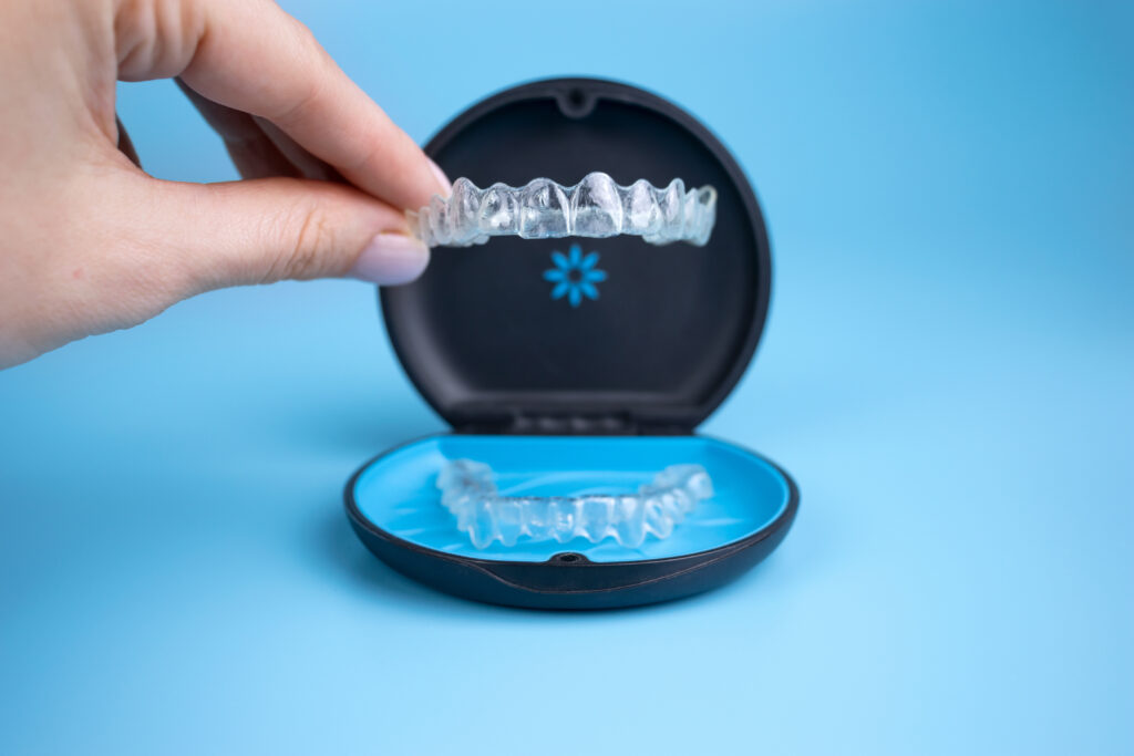 Woman holding invisalign transparent retainers